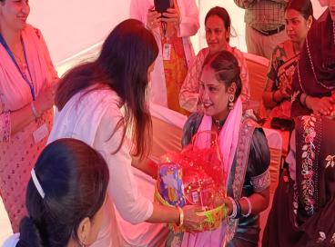 Honorable MP Kamaljeet Sherawat giving saugat to garbhani  in garbhani pariwar sammelan  stall at Mega camp in AyAM Vikas nagar 